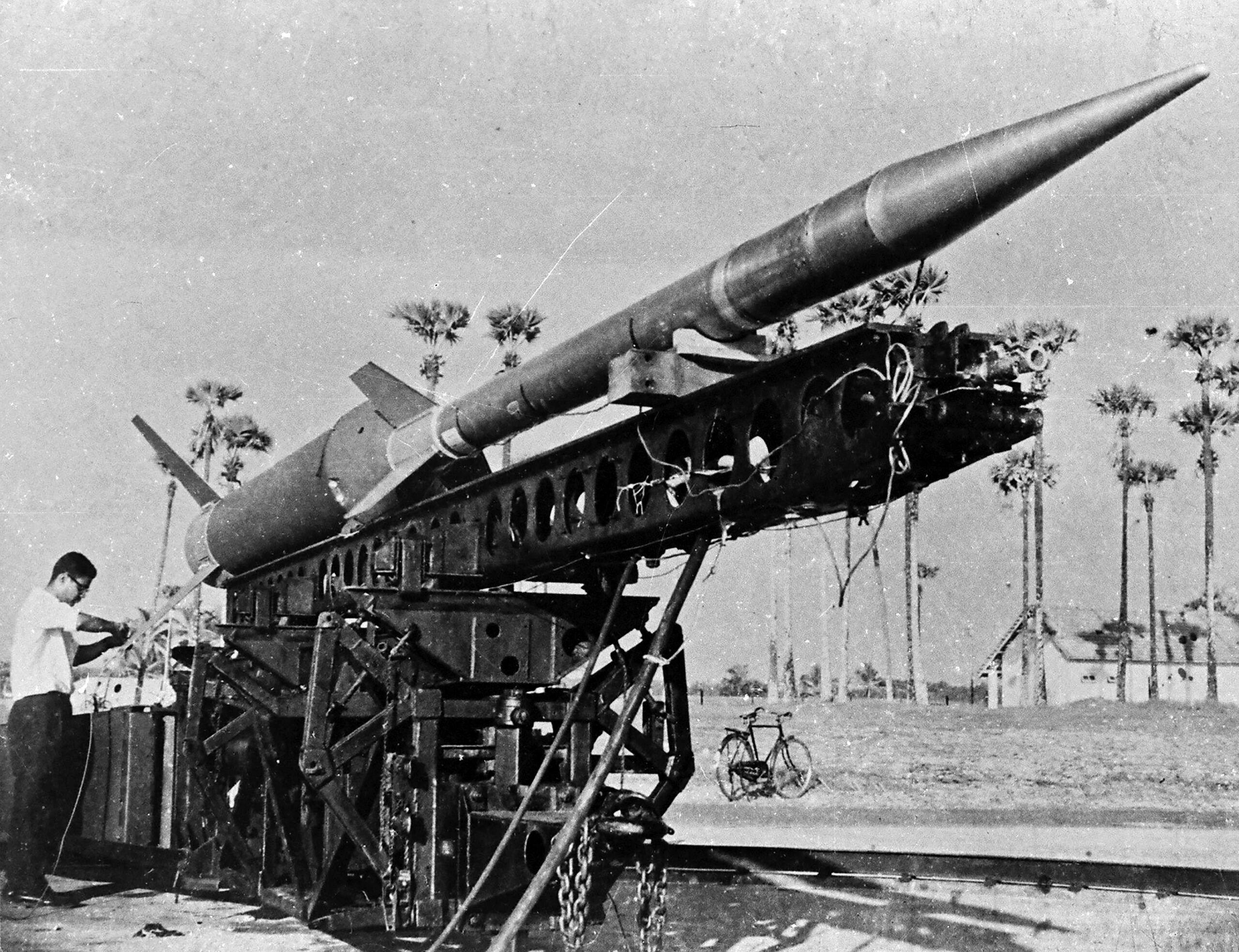 NASA also supplied Nike-Apache sounding rockets (including the one for the inaugural flight) and some tracking equipment. Nike is the name of the booster (or the first stage) while Apache is the name of the second stage. The picture shows an assembled Nike-Apache at Thumba. Note the bicycle in the background; it was the only readily available mode of transport in TERLS in the 1960s 