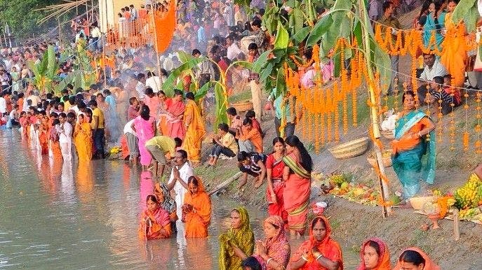 Ritual of taking a dip in the water of Chhath Puja