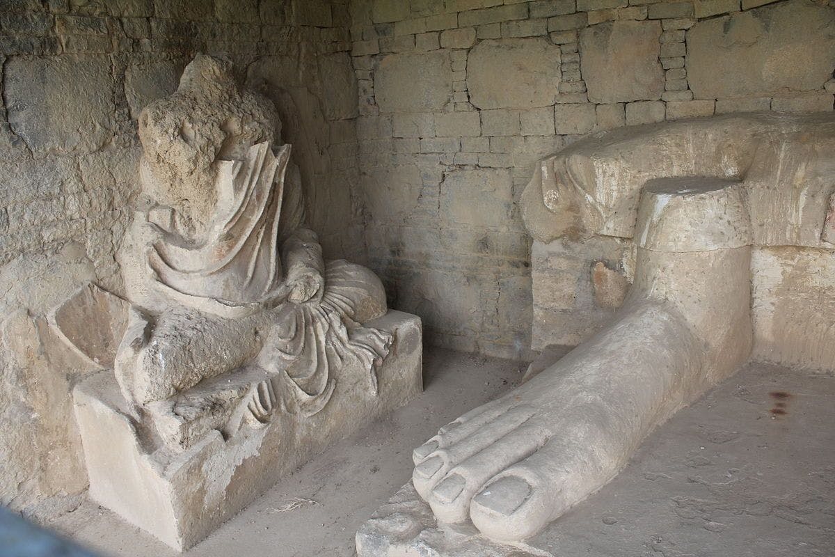 Stucco sculpture of Buddha and remnant feet of one of the largest stucco Buddha in Taxila