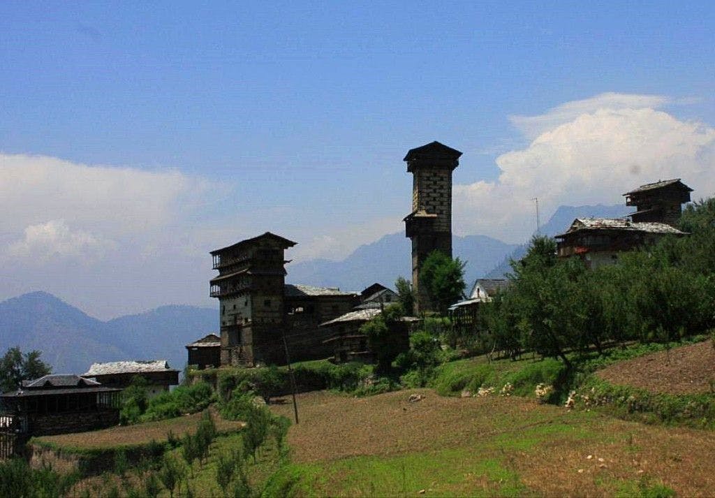 View of Chaini village, showing the soaring Chaini temple tower and the Thakurs’ Kothi over the village