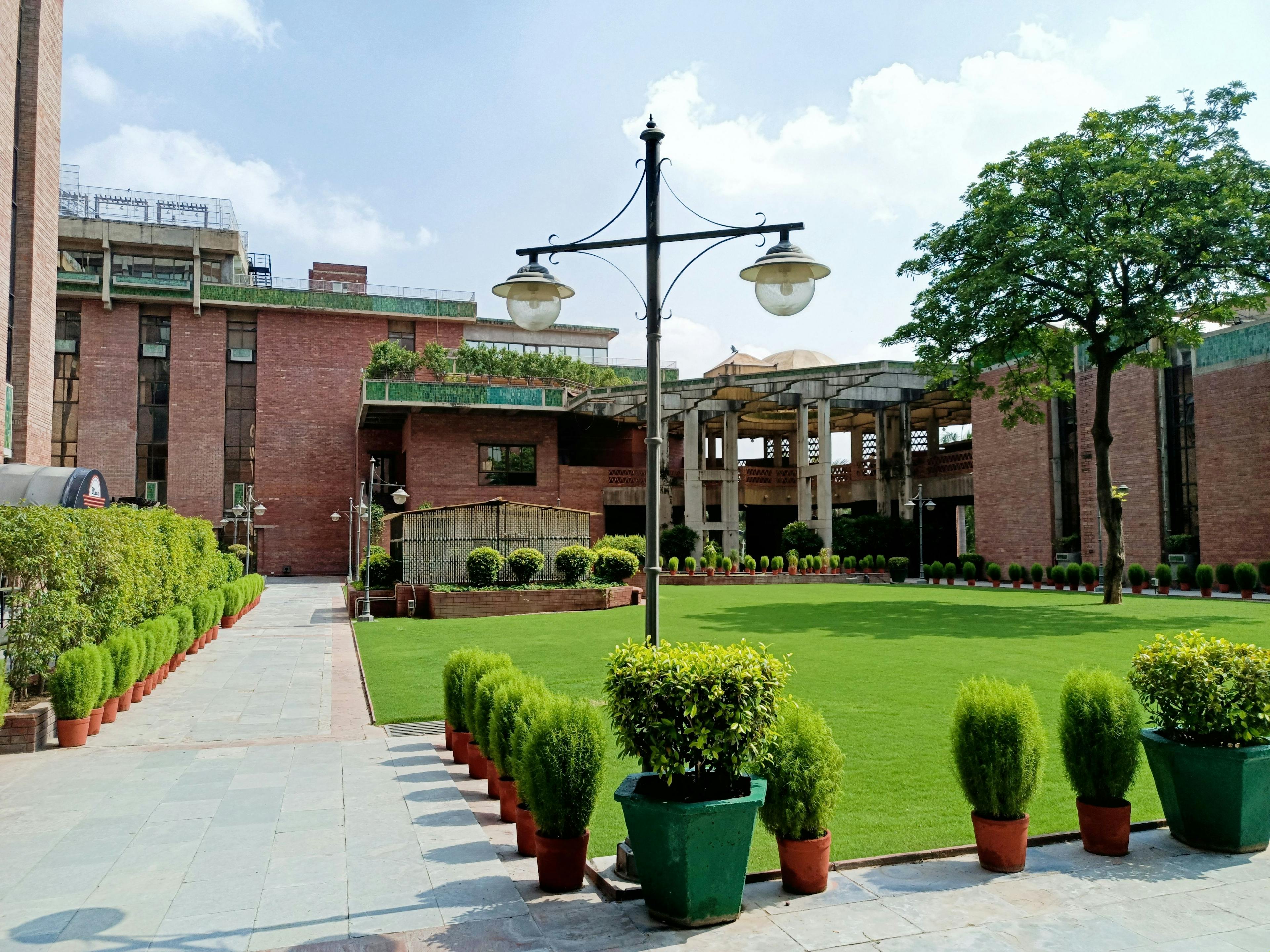 Wide green courtyards surrounded by offices, India Habitat Centre