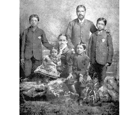 Aurobindo (seated center) and his familyin England, 1879